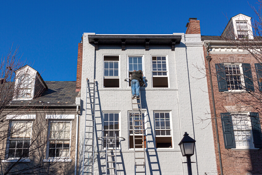 Person Painting the House Facade 
